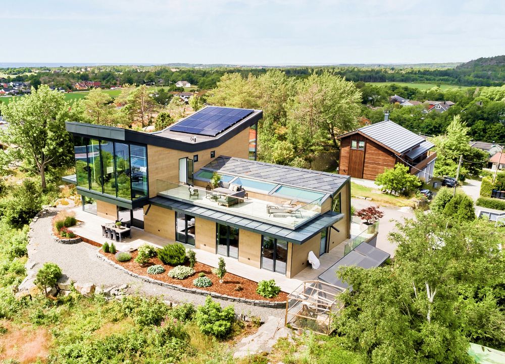 Modern Norwegian home with pool, aerial view
