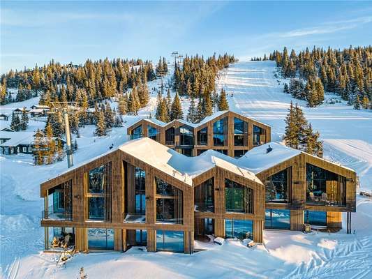 Modern ski chalet in snowy Norwegian mountains